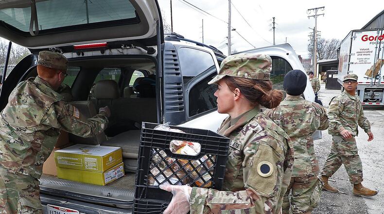 Ohio National Guard members based in Springfield helped distributed food during the coronavirus pandemic at the Second Harvest Food Bank as a line of cars, waiting for food, wrapped around the food bank.