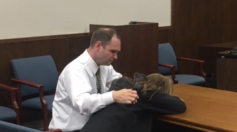 Jessica Langford is consoled by her husband after a jury last year found her guilty of having sex with a teen student in her Miamisburg Middle School classroom. NICK BLIZZARD/STAFF