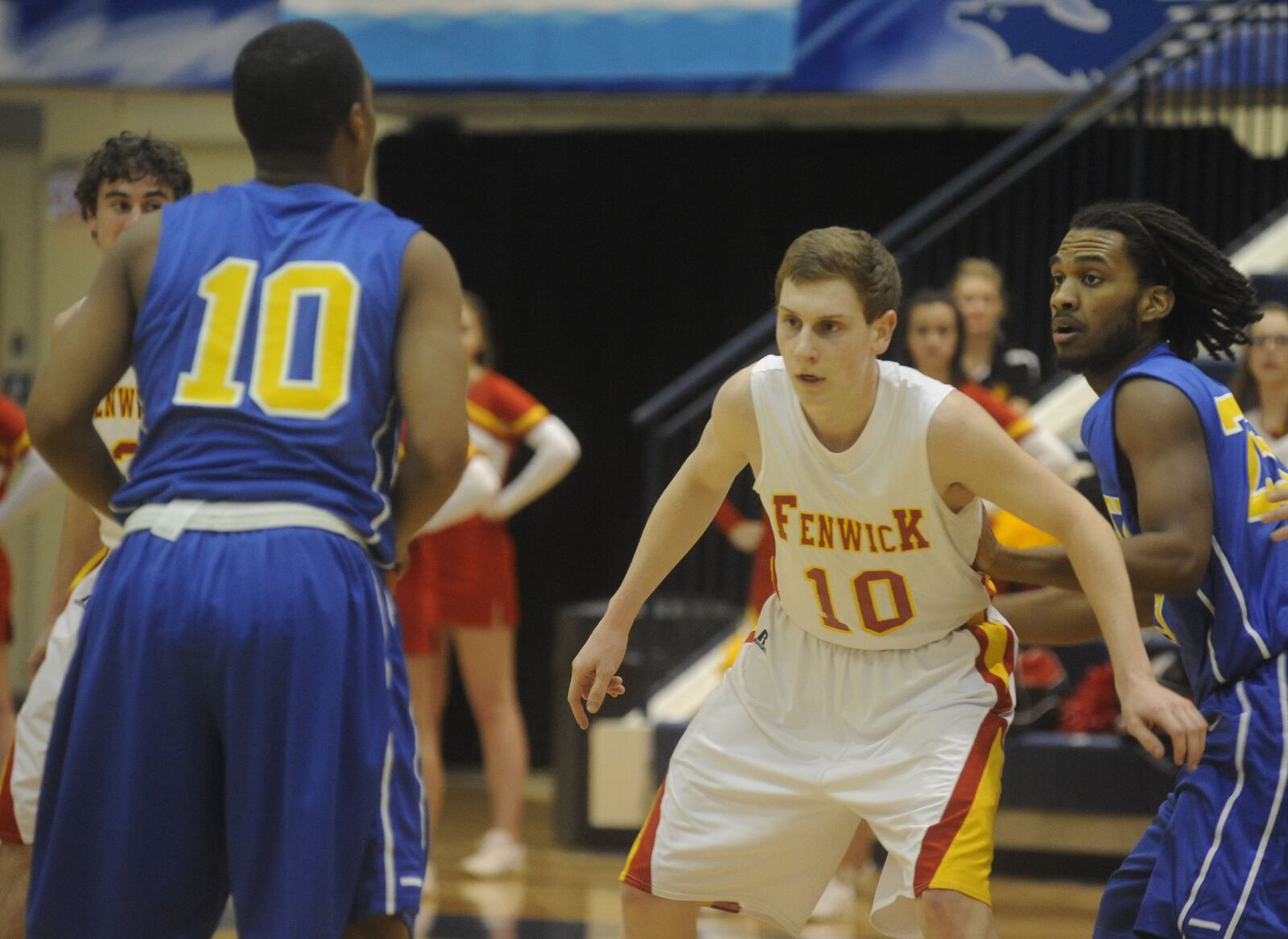 Fenwick’s Kevin Christie (10, white jersey) defends Yancy Smith of Ponitz (10) during a Division II sectional game at Fairmont’s Trent Arena on Feb. 25, 2014. MARC PENDLETON/STAFF