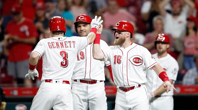 CINCINNATI, OH - MAY 22: Scooter Gennett #3 of the Cincinnati Reds celebrates with Tucker Barnhart #16 and Joey Votto #19 after hitting a grand slam in the fifth inning against the Pittsburgh Pirates at Great American Ball Park on May 22, 2018 in Cincinnati, Ohio. The Reds won 7-2. (Photo by Joe Robbins/Getty Images)