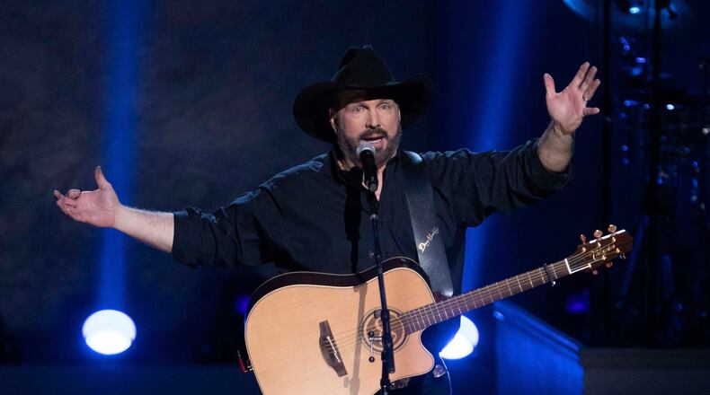 FILE - In this March 4, 2020, file photo, country star Garth Brooks performs on stage during the 2020 Gershwin Prize Honoree's Tribute Concert at the DAR Constitution Hall in Washington. Brooks is canceling his tour dates in five cities, citing a rising number of COVID-19 cases. He will cancel his planned next shows in Ohio, North Carolina, Maryland, Massachusetts and Tennessee. (Photo by Brent N. Clarke/Invision/AP, File)