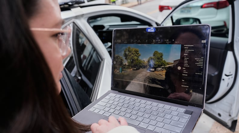 Chelsea Palacio, public information manager for the City of San Jose, showcases how a small detection camera uses AI to detect road hazards and potholes, in San Jose, Calif., Wednesday, Nov. 12, 2025. (AP Photo/Godofredo A. Vásquez)
