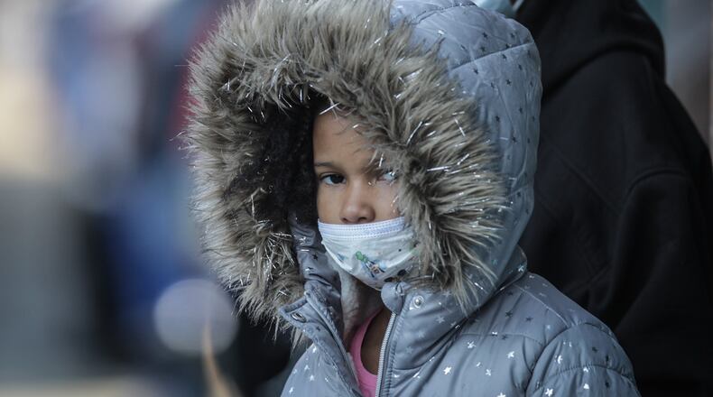 In this file photo, De'Auna Jones, left and Denise Shaw wait for the bus at Main and Third Streets both wearing masks. "I am tired of wearing the mask," Shaw said, "but if its going to save lives, that why we do it."