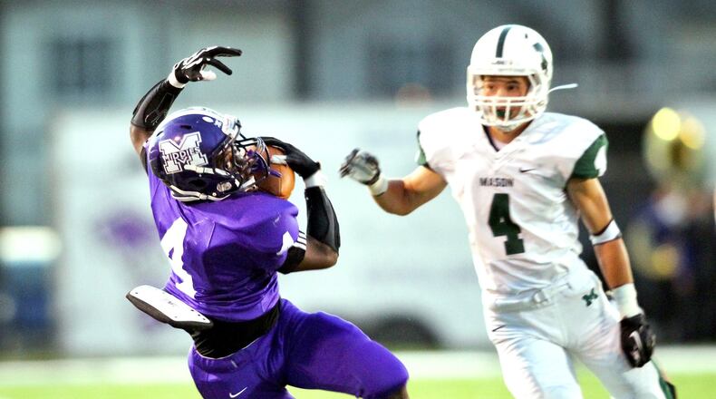 Middletown’s E.J. Colson (4) catches a deep pass behind Mason’s Ryan Rabas (4) during the first quarter of a Sept. 27, 2013 game at Barnitz Stadium in Middletown. COX MEDIA FILE PHOTO