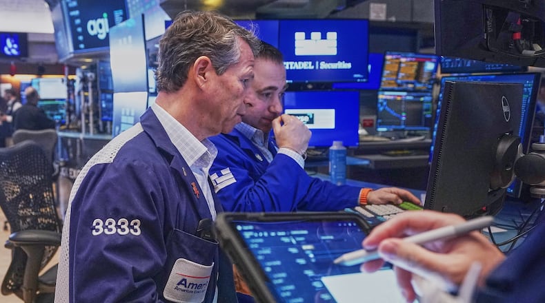 Trader Robert Charmak, left, and Specialist Genarro Saporito work on the floor of the New York Stock Exchange, Wednesday, Feb. 11, 2026. (AP Photo/Richard Drew)