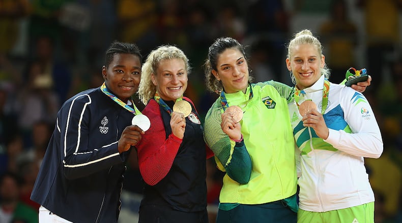 RIO DE JANEIRO, BRAZIL - AUGUST 11: Silver medalist Audrey Tcheumeo of France, gold medalist Kayla Harrison of the United States and bronze medalists Mayra Aguiar of Brazil and Anamari Velensek of Slovenia celebrate on the podium after the women’s -78kg judo contest on Day 6 of the 2016 Rio Olympics at Carioca Arena 2 on August 11, 2016 in Rio de Janeiro, Brazil. (Photo by Julian Finney/Getty Images)