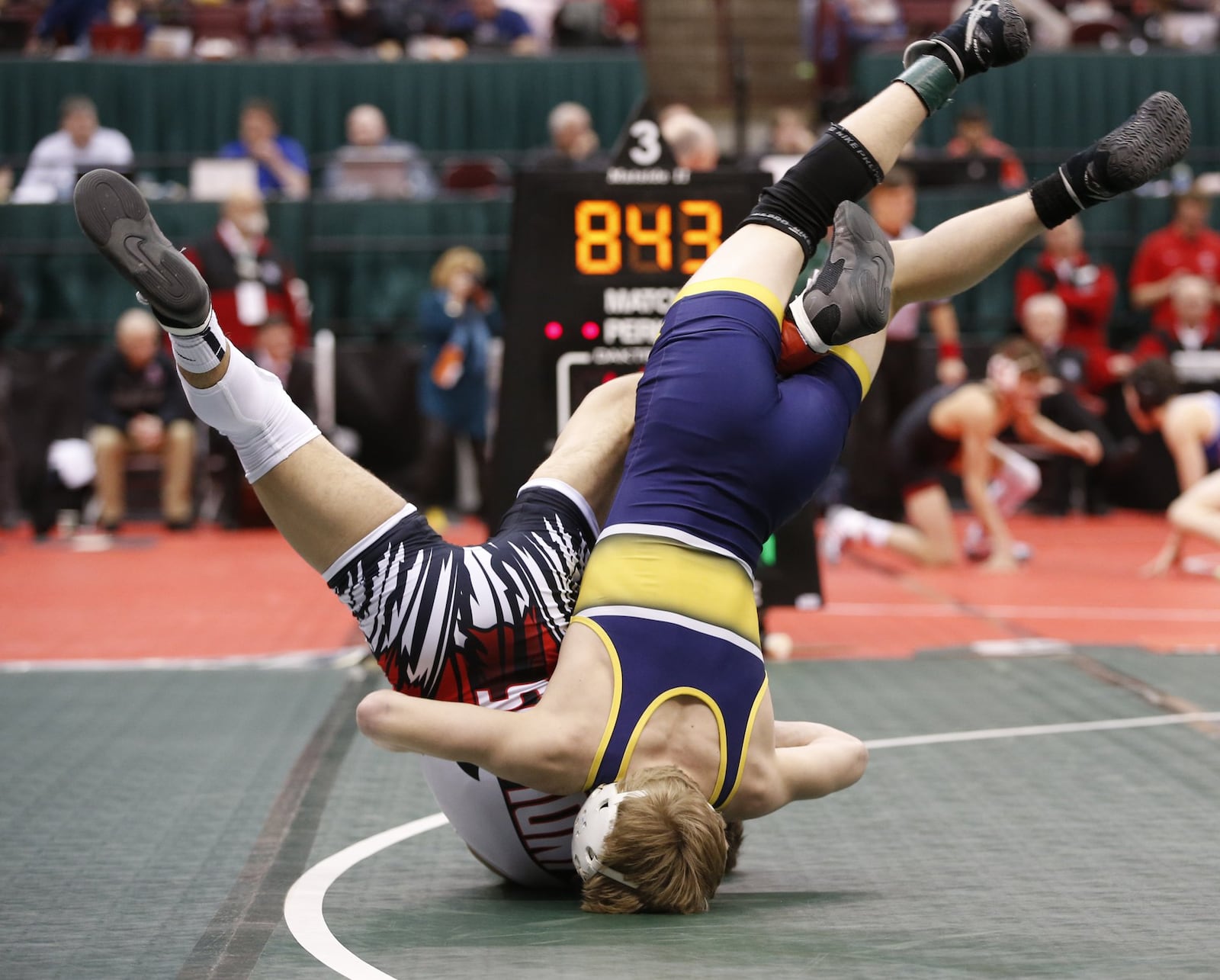 Logan Agin (blue) of Lancaster and Zach Shupp (red) of Fairfield wrestle at 106 pounds in Division I state wrestling action Friday at the Schottenstein Center in Columbus. BARBARA J. PERENIC/COLUMBUS DISPATCH