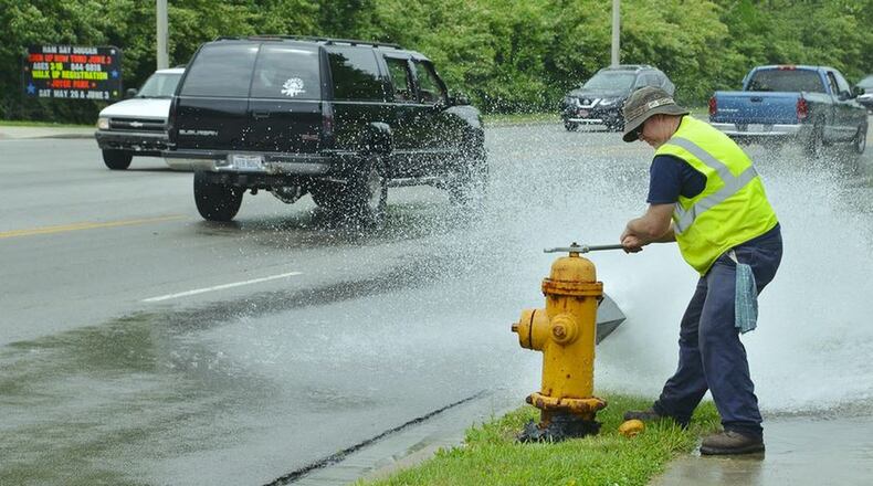 A Hamilton employee flushes a fire hydrant, a process in which crews check the hydrants. The flushing also clears water mains of sediment that can accumulate. PROVIDED