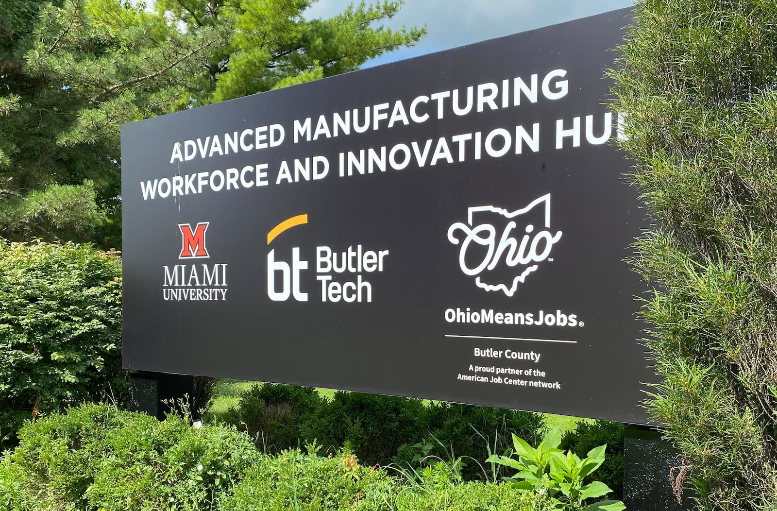 The joint project converting the former VORA technology park, which previously was the Knightsbridge Road headquarters for Hamilton-based Champion Paper Company during its final years, involves the largest partnership between Butler Tech and Miami University in the career school’s history. Other financial partners include the Butler County Commissioners, city of Hamilton and various state and federal funding grants. Pictured is large sign on the new school's campus. (Photo By Michael D. Clark/Journal-News)