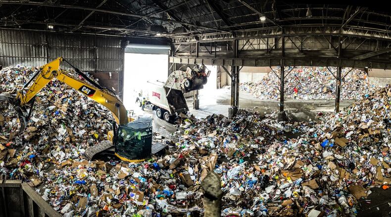 Rumpke dumps trash into its large recycling facility on Monument Ave. Glass and cardboard are separated and recycled. JIM NOELKER/STAFF