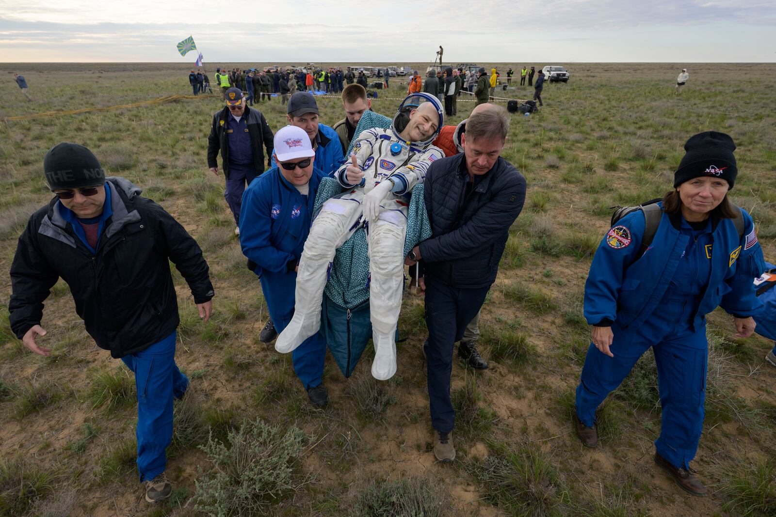 NASA astronaut Don Pettit gestures as he is carried to a medical tent shortly after landing in a Soyuz MS-26 spacecraft with Roscosmos cosmonauts Alexey Ovchinin and Ivan Vagner near the town of Zhezkazgan, Kazakhstan, Sunday, April 20, 2025, (Bill Ingalls/NASA via AP)
