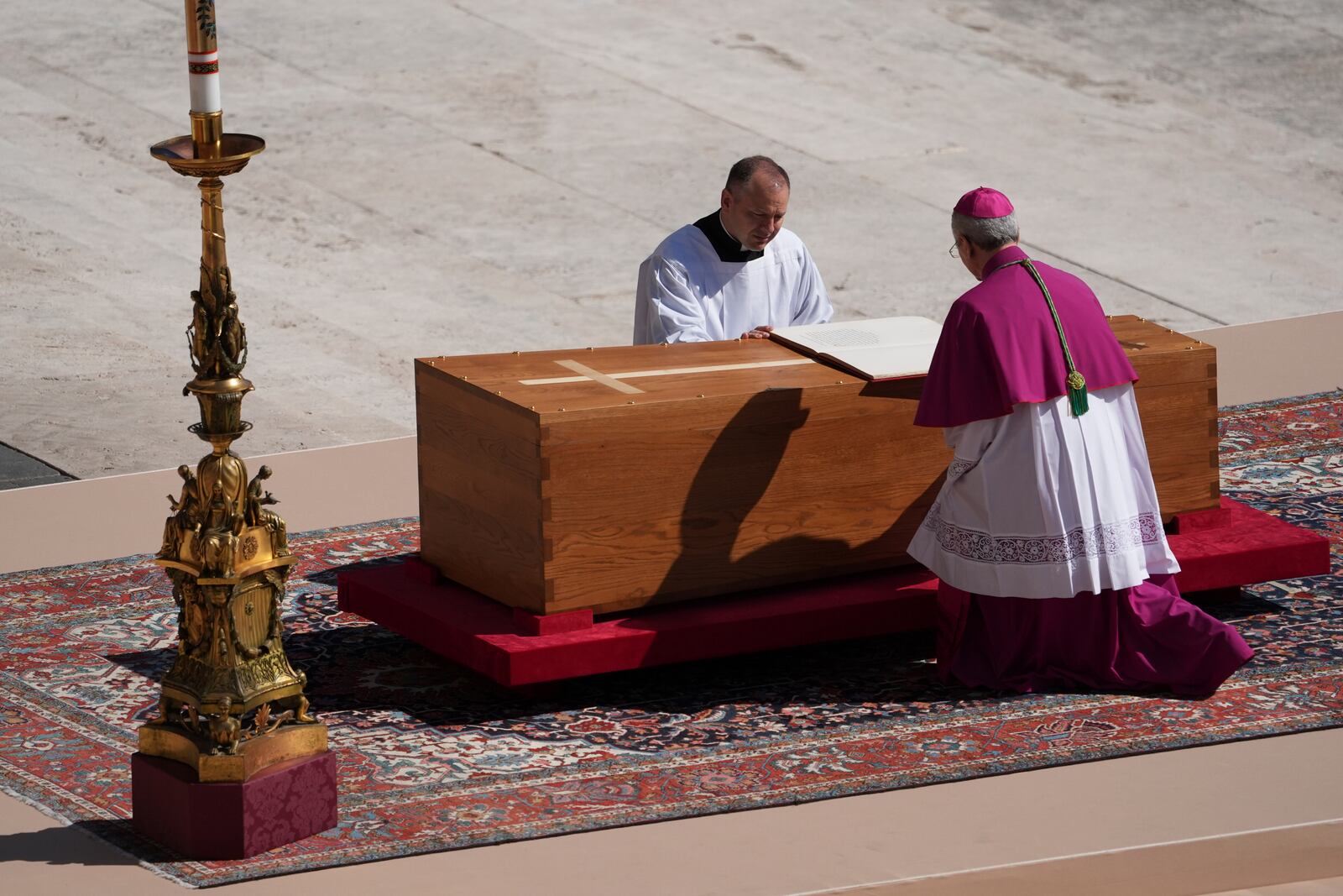 Archbishop Diego Giovanni Ravelli, kneeling right, presides over the funeral of Pope Francis in St. Peter's Square at the Vatican, Saturday, April 26, 2025. (AP Photo/Evan Vucci)