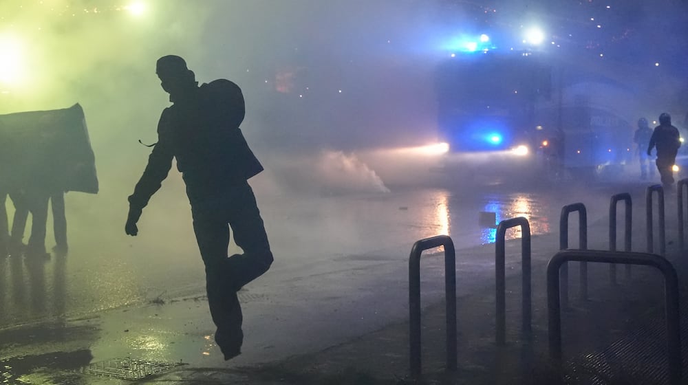 Demonstrators face riot police during a protest against the Milan-Cortina 2026 Olympics, in Milan, Italy, Saturday Feb. 7, 2026. (Claudio Furlan/LaPresse via AP)