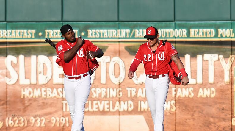 The Reds are full of new faces this year, like outfielder Yasiel Puig (left) and utility player Derek Dietrich. (Photo by Norm Hall/Getty Images)