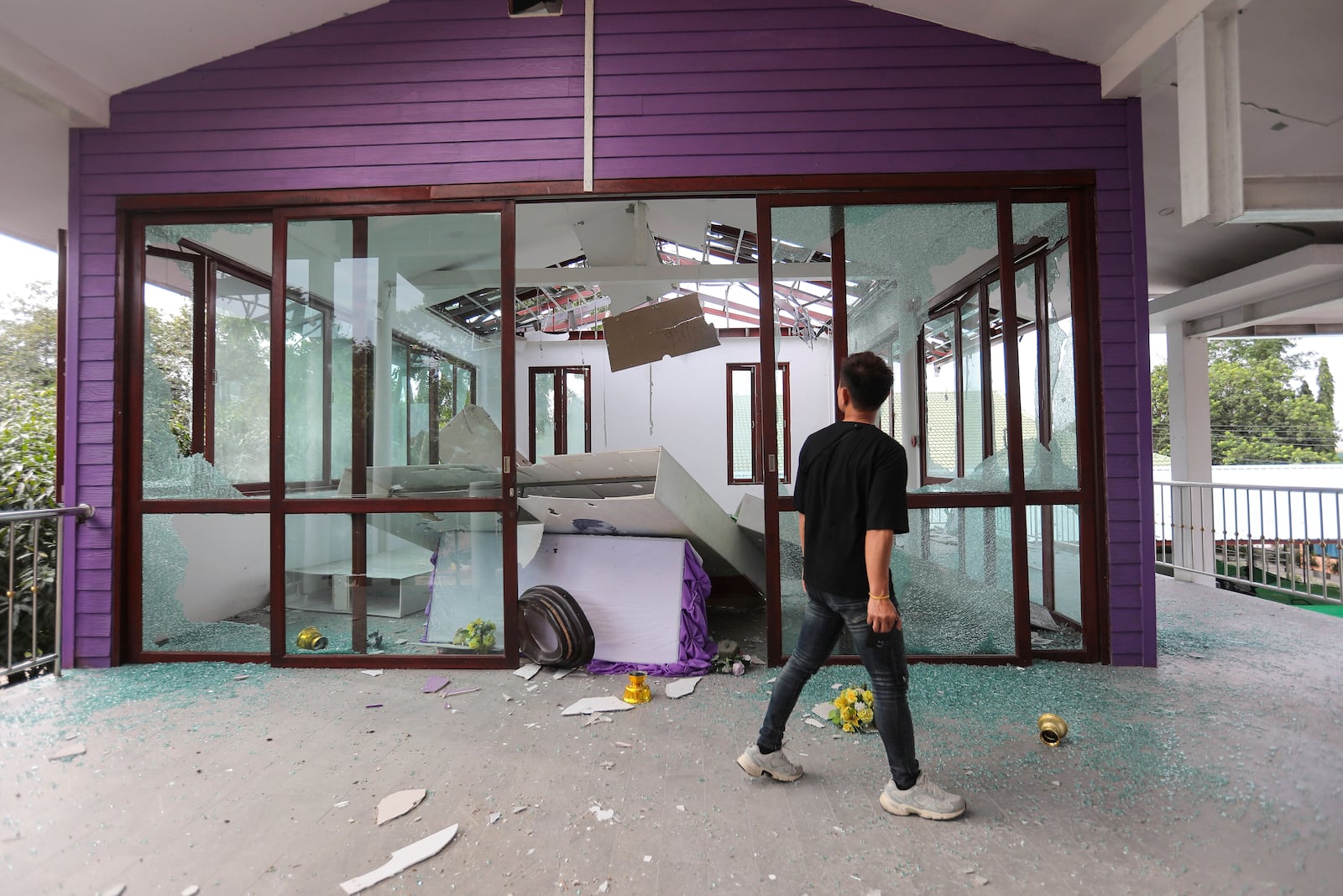 Thai people looks at the damage of Phanom Dong Rak hospital after Cambodia fired artillery shells at Surin Province, Thailand, Thursday, July 24, 2025. (AP Photo/Sunny Chittawil)