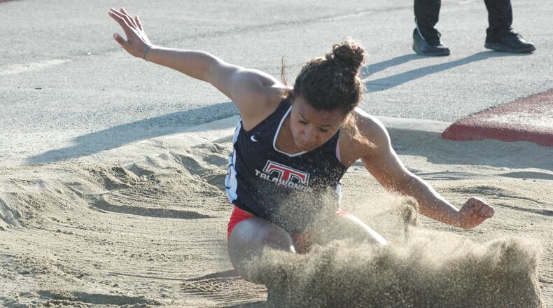 Talawanda’s Kyra Koontz lands in the long-jump pit Tuesday during the ninth annual Dale Plank Invitational track & field meet at Talawanda. Koontz won four individual events, helping the host Brave win the girls team championship. RICK CASSANO/STAFF