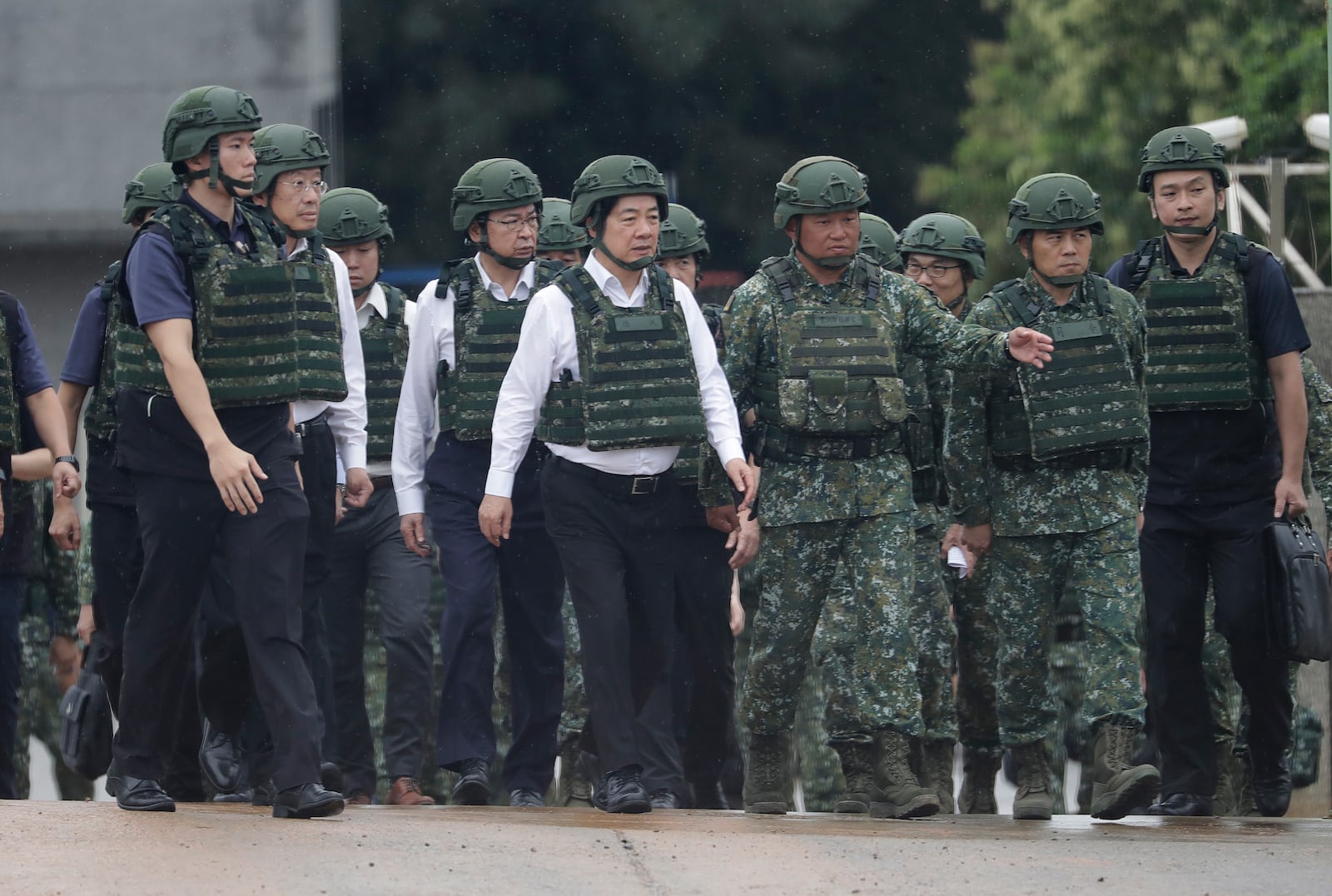 Taiwan President Lai Ching-te, center, inspects a live-fire shooting training in Hsinchu County, Taiwan, Thursday, July 10, 2025. (AP Photo/Chiang Ying-ying)