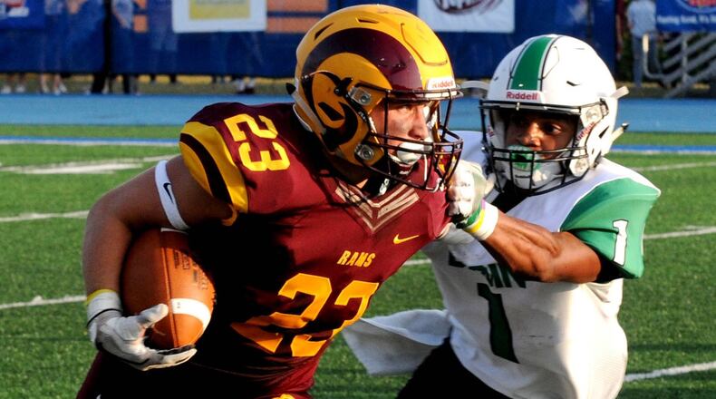 Ethan Mills of Ross (23) attempts to elude Badin’s Davon Starks (1) during the teams’ season opener Aug. 25, 2017, at Hamilton’s Virgil Schwarm Stadium. Badin won 36-6. CONTRIBUTED PHOTO BY DAVID A. MOODIE