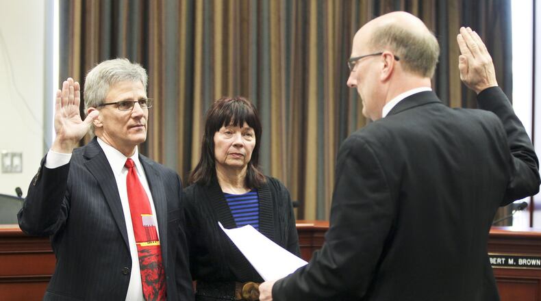 Council Member Rob Wile, with his wife Nancy, was given the oath of office to start his second term by Mayor Pat Moeller in January of 2014. GREG LYNCH / STAFF