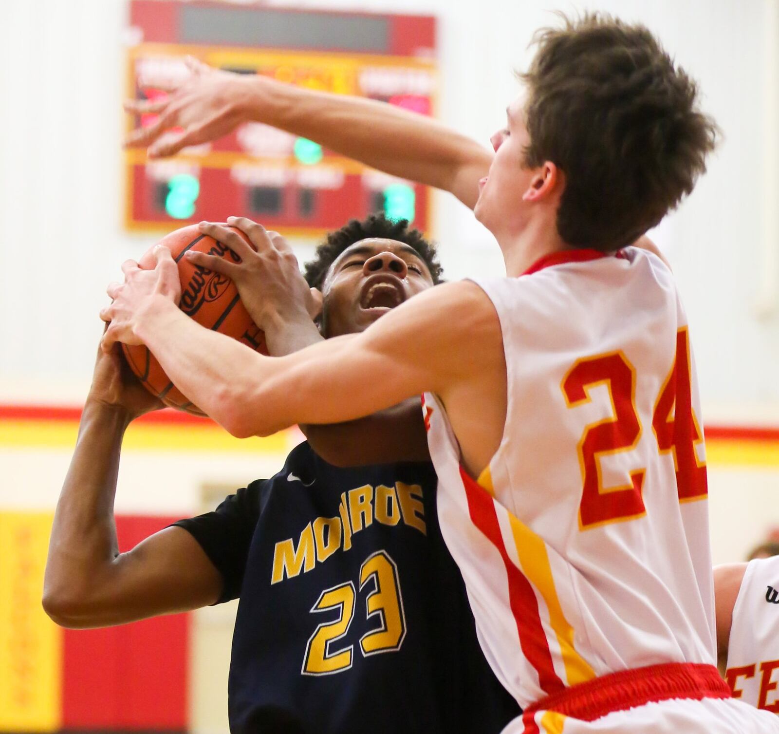 Monroe forward Tristan Backas (23) is fouled by Fenwick’s David Luers (24) during their game at Fenwick on Tuesday night. GREG LYNCH/STAFF