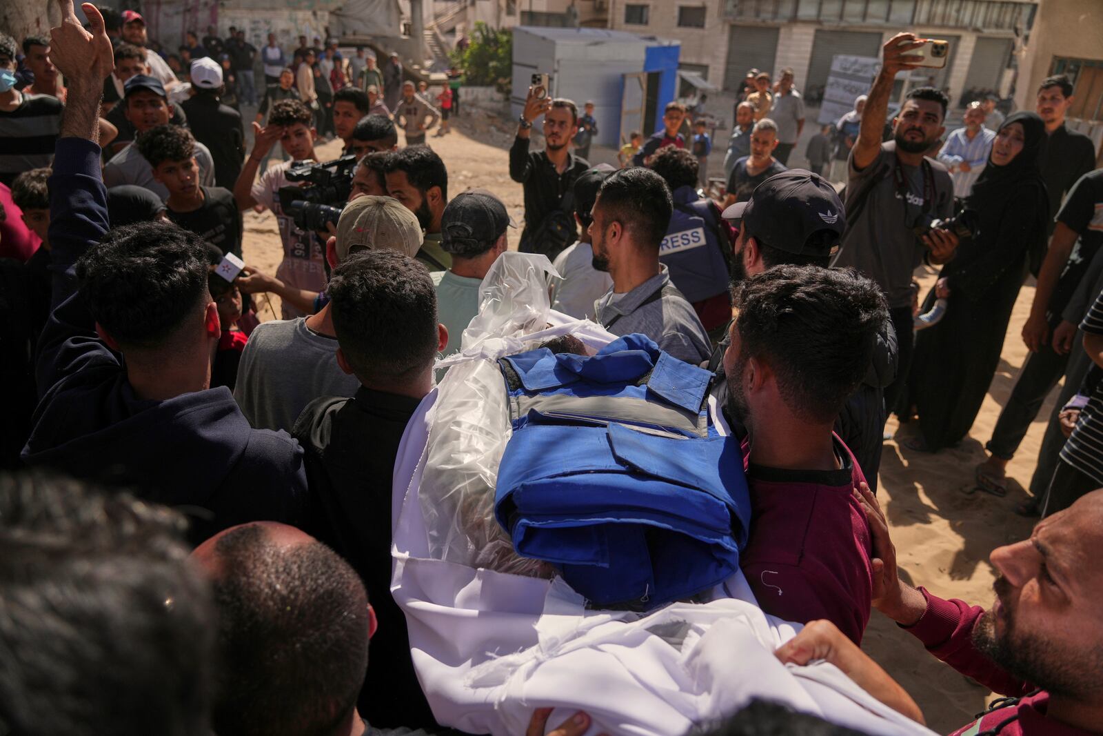 The body of Palestinian journalist Yahya Sobeih, who was killed along with at least 28 others in an Israeli army strike on a restaurant, is carried for burial at Shifa hospital in Gaza City, Wednesday, May 7, 2025.