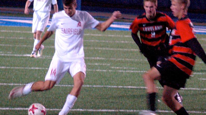 Fairfield’s Evan Van Rheenen makes a pass as two Loveland defenders move in Tuesday night during a Division I sectional final at Hamilton’s Virgil Schwarm Stadium. Loveland advanced with a 3-0 win. CONTRIBUTED PHOTO BY JOHN CUMMINGS