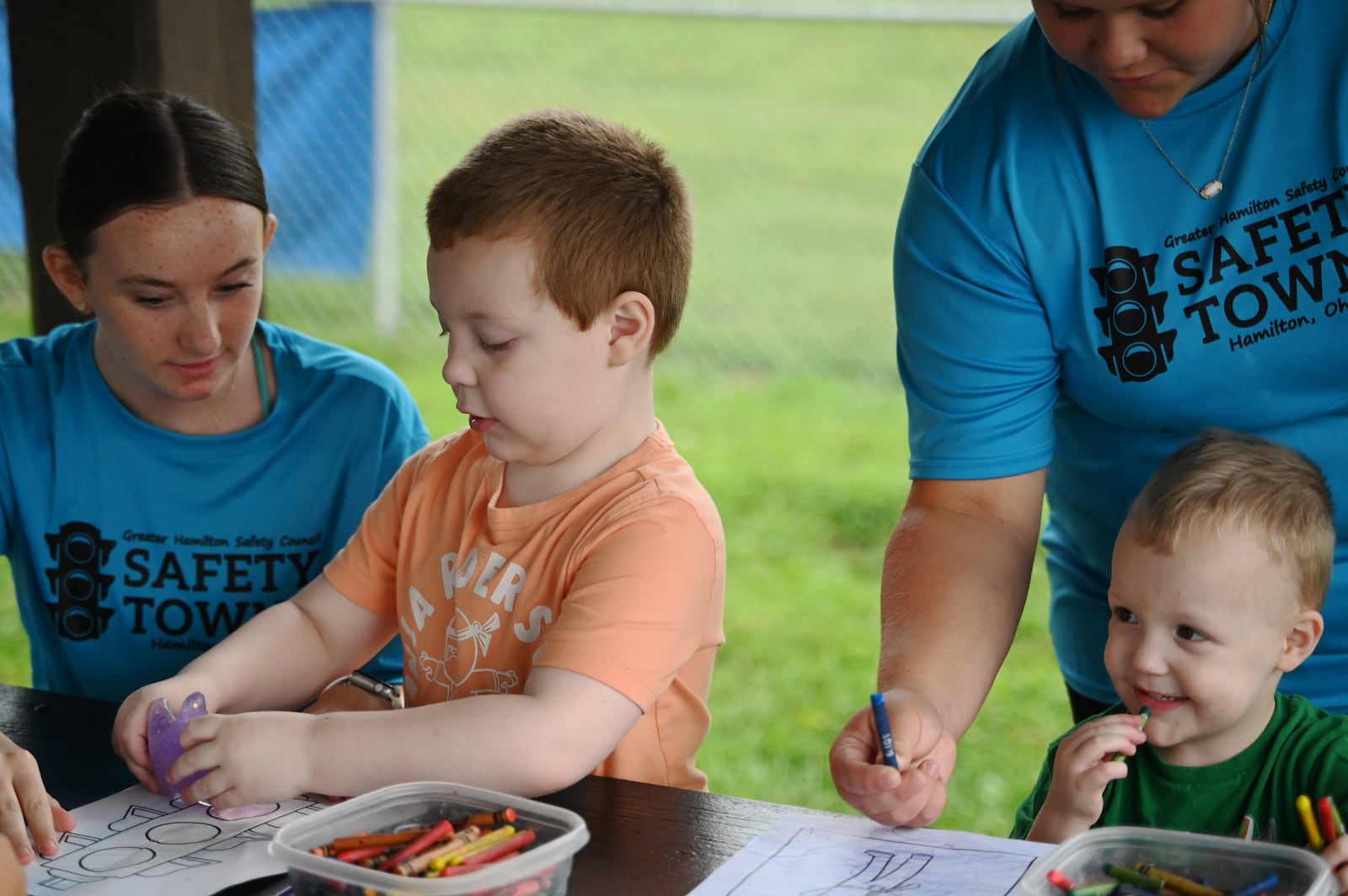 The Butler County Board of Development Disabilities and the Hamilton Safety Council partnered to offer a pilot program for kids with developmental disabilities to participate in Safety Town. Four and 5 year-olds are participating in the pilot program now through Aug. 2 at Officer Bob Gentry Park in Hamilton. From Aug. 5 to 9, kids ages 6 to 8 will participate in Safety Town. Pictured is Caleb (center left) working with volunteer Ava Ramsey, a junior at Hamilton High School (left), and Payton Niehause, a Freshman at Fairfield High School (right) working with Lucas. MICHAEL D. PITMAN/STAFF