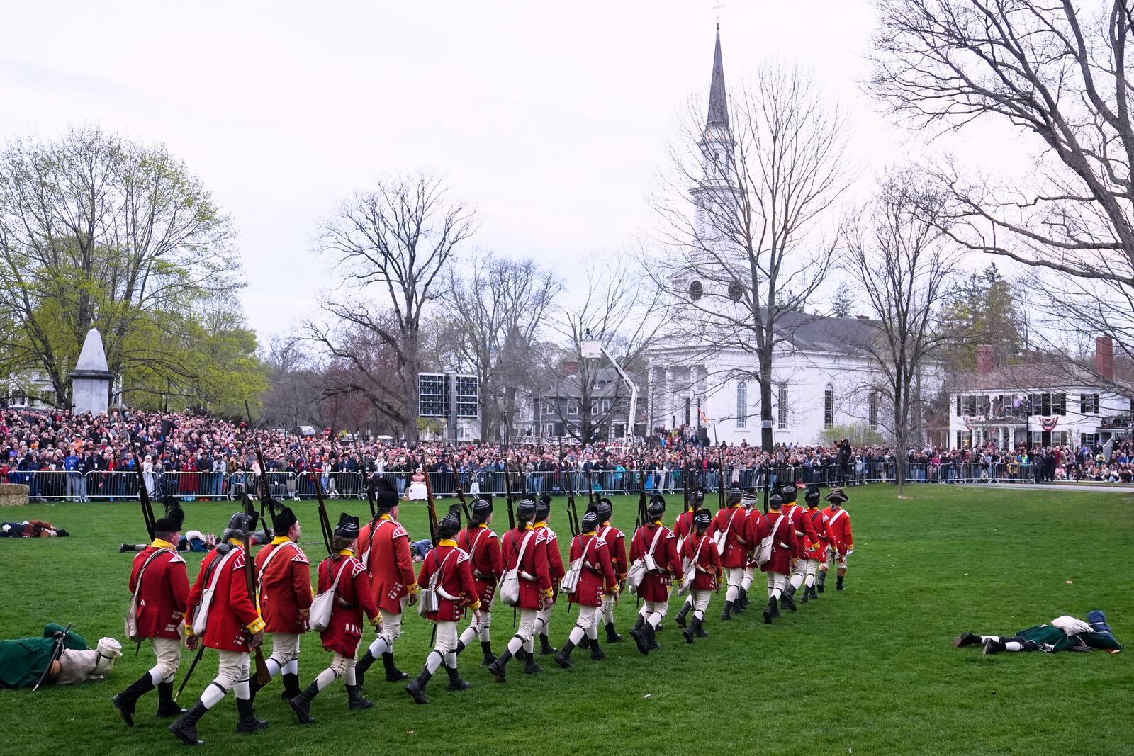 British Regulars march past fallen New England colonial militia, also known as a Minuteman, during a reenactment celebration of the 250th anniversary of the Battle of Lexington and start of the American Revolution, Saturday, April 19, 2025, in Lexington, Mass. (AP Photo/Charles Krupa)