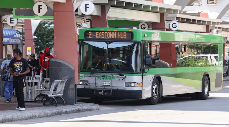 Passengers enter a Greater Dayton RTA bus at Wright Stop Plaza Transit Center on Friday, June 27. If a locally backed provision in the state’s recently passed budget becomes law, Dayton Public Schools may cease to provide any transportation options for students. BRYANT BILLING / STAFF