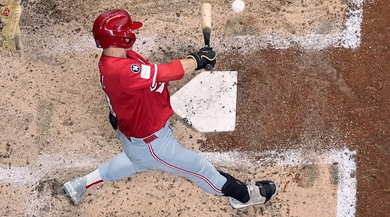 Cincinnati Reds' TJ Friedl hits a two-run RBI single during the third inning of a baseball game against the Milwaukee Brewers Saturday, Sept. 27, 2025, in Milwaukee. (AP Photo/Morry Gash)