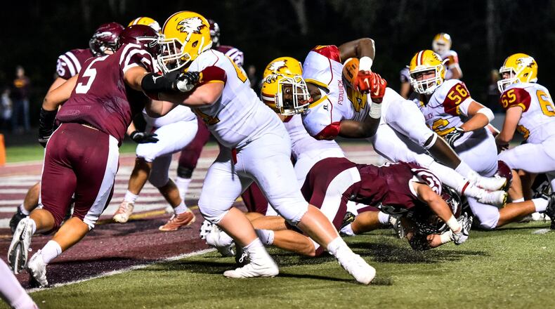 Fenwick’s Caleb Davis carries the ball for a touchdown during their game against Lebanon on Sept. 8 at VanDeGrift Stadium in Lebanon. The host Warriors won 49-27. NICK GRAHAM/STAFF