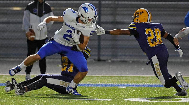 Springboro's Drew Balogh is tackled by Springfield's Rashad Walker Cherry and Ty'Juan Wright. BILL LACKEY/STAFF