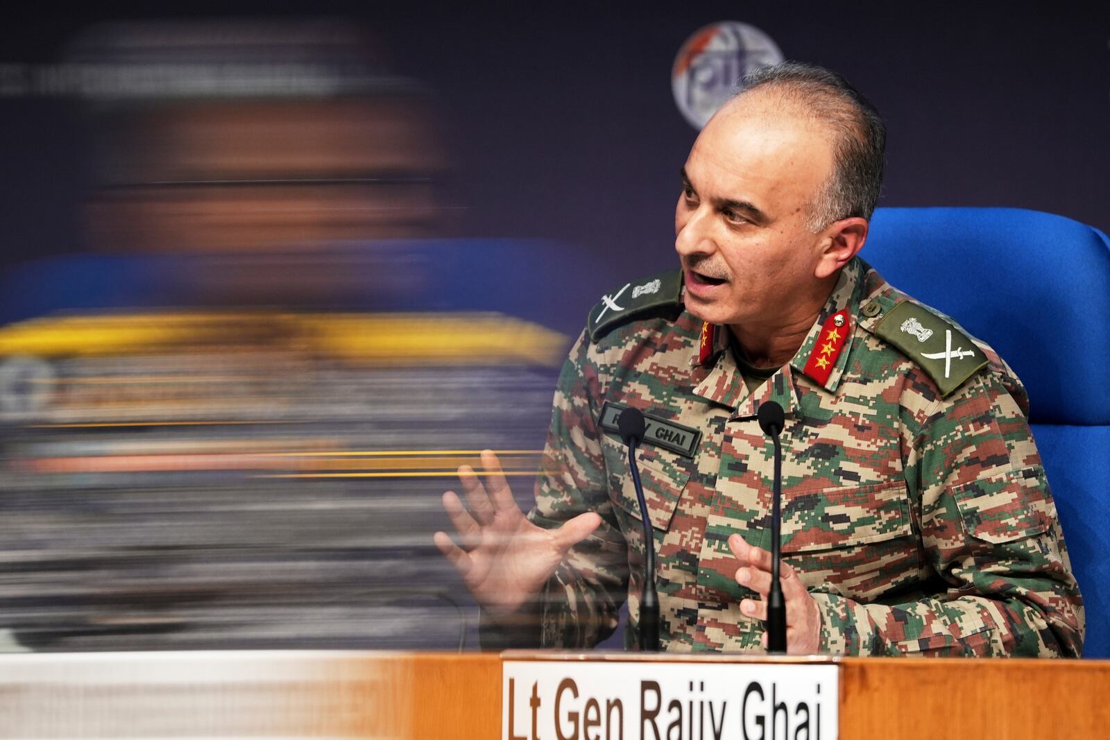 Director General of Military Operations Lt. Gen. Rajiv Ghai speaks during a press conference as a blurred reflection of Vice Admiral AN Pramod is seen on a glass pane, in New Delhi, Sunday, May 11, 2025. (AP Photo/Karma Bhutia)