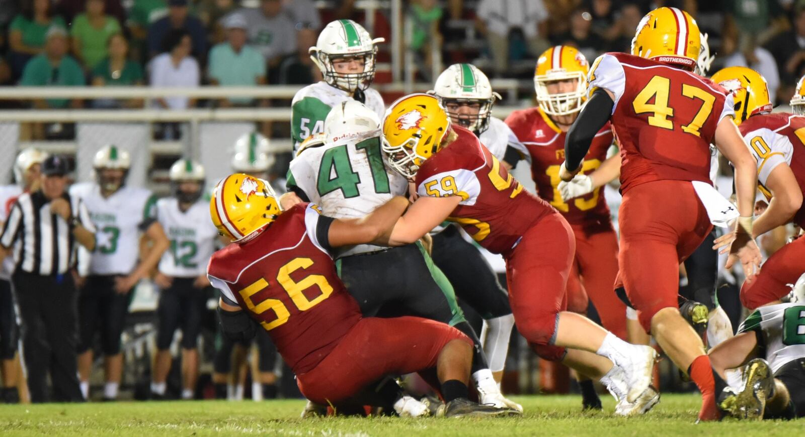 Fenwick’s Sam Secrest (56) and Leo Bell (59) tackle Badin’s Ethan Wishart (41) on Friday night at Krusling Field in Middletown. Fenwick won 21-9. CONTRIBUTED PHOTO BY ANGIE MOHRHAUS