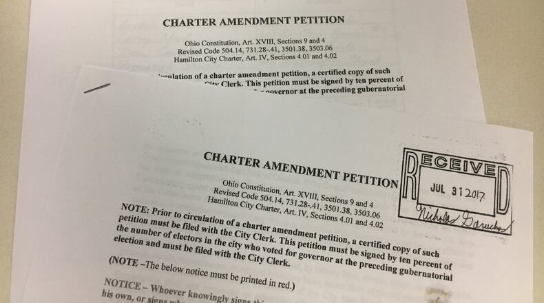 These petitions are being circulated by Citizens For Change to create term limits and require that four members of Hamilton City Council be elected from separate wards. MIKE RUTLEDGE/STAFF