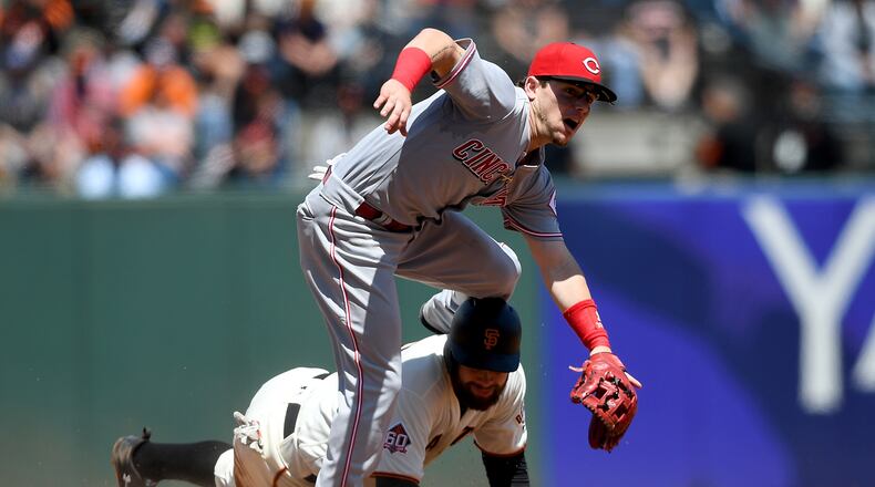 SAN FRANCISCO, CA - MAY 16:  Scooter Gennett #3 of the Cincinnati Reds leaps over Brandon Belt #9 of the San Francisco Giants after getting his throw off to complete the douple play in the bottom of the fifth inning at AT&T Park on May 16, 2018 in San Francisco, California.  (Photo by Thearon W. Henderson/Getty Images)