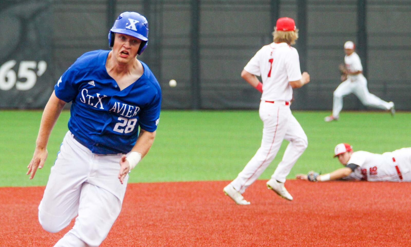 St. Xavier’s Alex Markley (28) heads towards third base and then around to score Thursday during a Division I regional semifinal against Fairfield at the University of Cincinnati’s Marge Schott Stadium. GREG LYNCH/STAFF