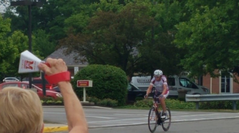 Mickey Simonds rings a cowbell as rider Thomas Haas comes through Oxford. BRENNEN KAUFFMAN/STAFF