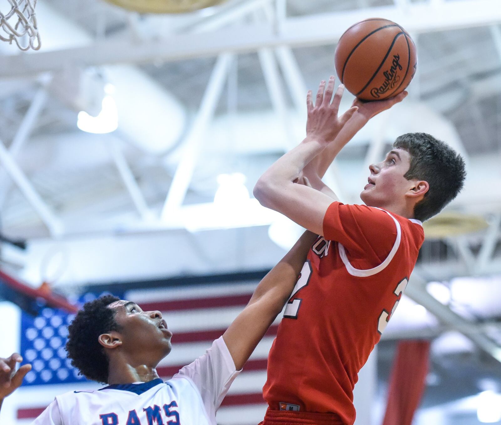 Miami Valley’s Marc Williams defends a shot by Madison’s Grant Whisman during Thursday night’s Brian Cook Classic in Madison Township. NICK GRAHAM/STAFF