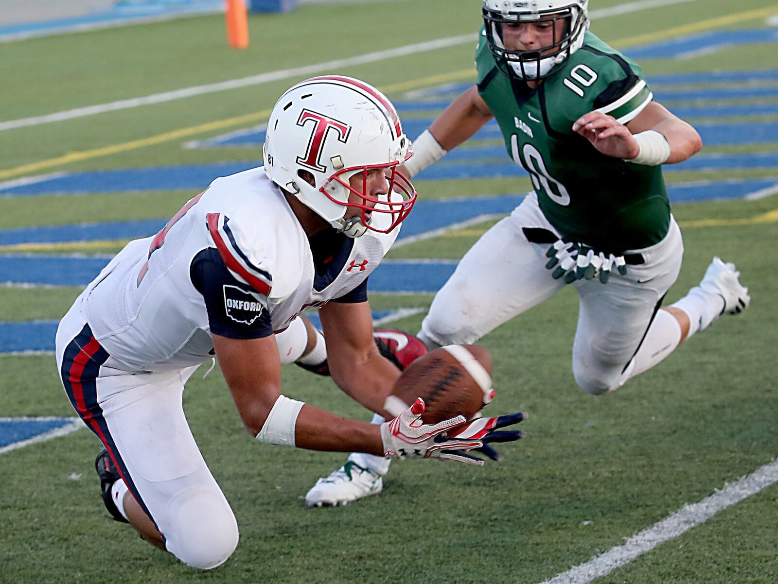 Talawanda tight end Andrew O’Donnell catches a touchdown pass under pressure from Badin defensive back A.J. Ernst during their game at Virgil Schwarm Stadium in Hamilton on Sept. 3, 2-16. CONTRIBUTED PHOTO BY E.L. HUBBARD