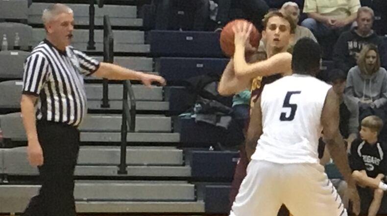 Ben Yeager of Ross (with ball) is guarded by Edgewood’s Tyrevis Hill earlier this season at Ron Kash Court in Trenton. RICK CASSANO/STAFF