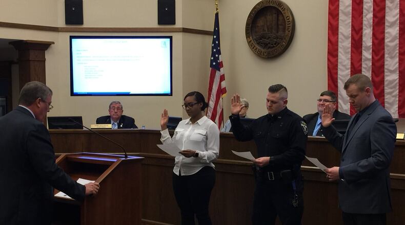 Monroe Law Director Phil Callahan swears-in the city’s newest police officers at the Jan. 28 meeting of City Council. The new officers, from left, are Monique Lockett, Greg Hopkins and Greg Gattermeyer. Hopkins previously served three years with Hamilton police and is on the job in Monroe. Lockett and Gattermeyer are in the basic police training academy at the Ohio State Highway Patrol Academy in Columbus. ED RICHTER/STAFF