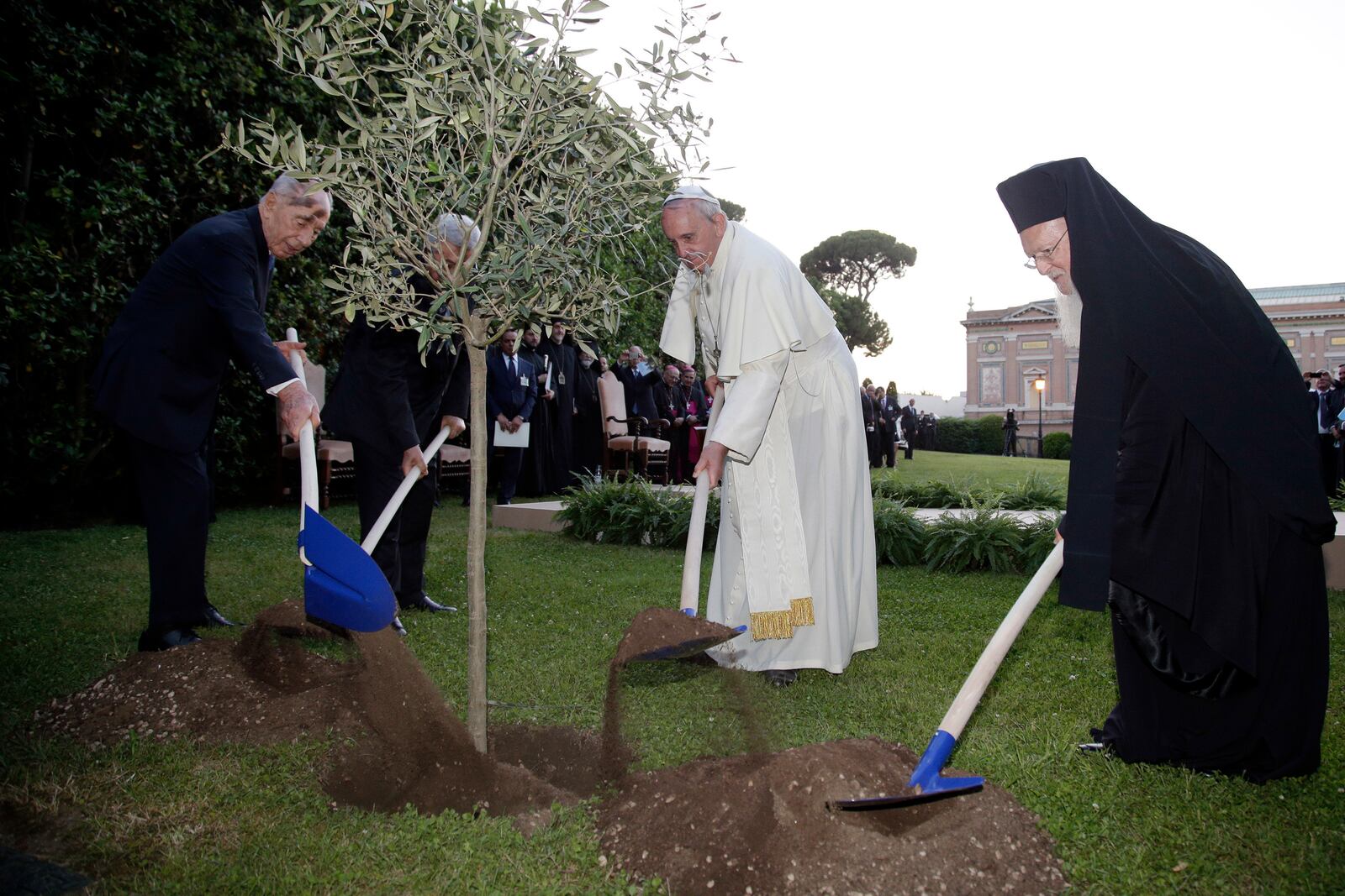 FILE - Pope Francis plants an olive tree with Israel's President Shimon Peres, left, Palestinian President Mahmoud Abbas, second from left, and Ecumenical Patriarch Bartholomew I, right, in a sign of peace during an evening of peace prayers in the Vatican gardens, Sunday, June 8, 2014. (AP Photo/Max Rossi, Pool, File)