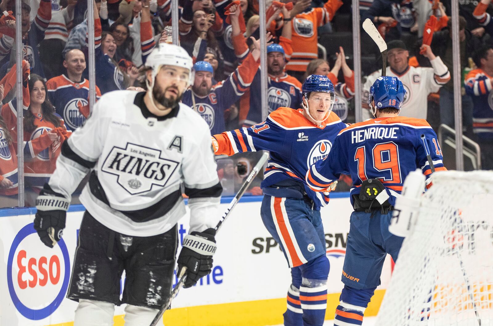 Edmonton Oilers' Trent Frederic (21) and Adam Henrique (19) celebrate a goal as Los Angeles Kings' Drew Doughty (8) skates past during the second period of an NHL hockey game in Edmonton, Alberta, Thursday, May 1, 2025. (Jason Franson/The Canadian Press via AP)