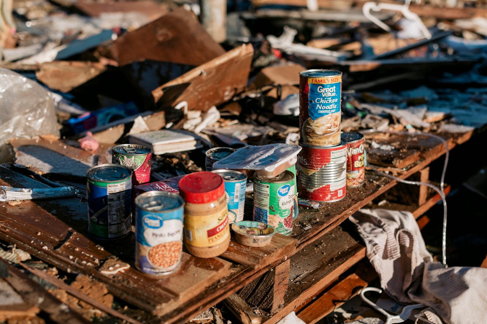 Salvaged food items in Dawson Springs, Ky., on Monday, Dec. 13, 2021, where a tornado flattened much of the town on Friday night. After grimly fluctuating death tolls since Friday’s devastating swarm of tornadoes, Gov. Andy Beshear of Kentucky said on Monday that there were 64 confirmed deaths in the state, though he expected that number to rise as crews continued to search through the ruins. (William Widmer/The New York Times)