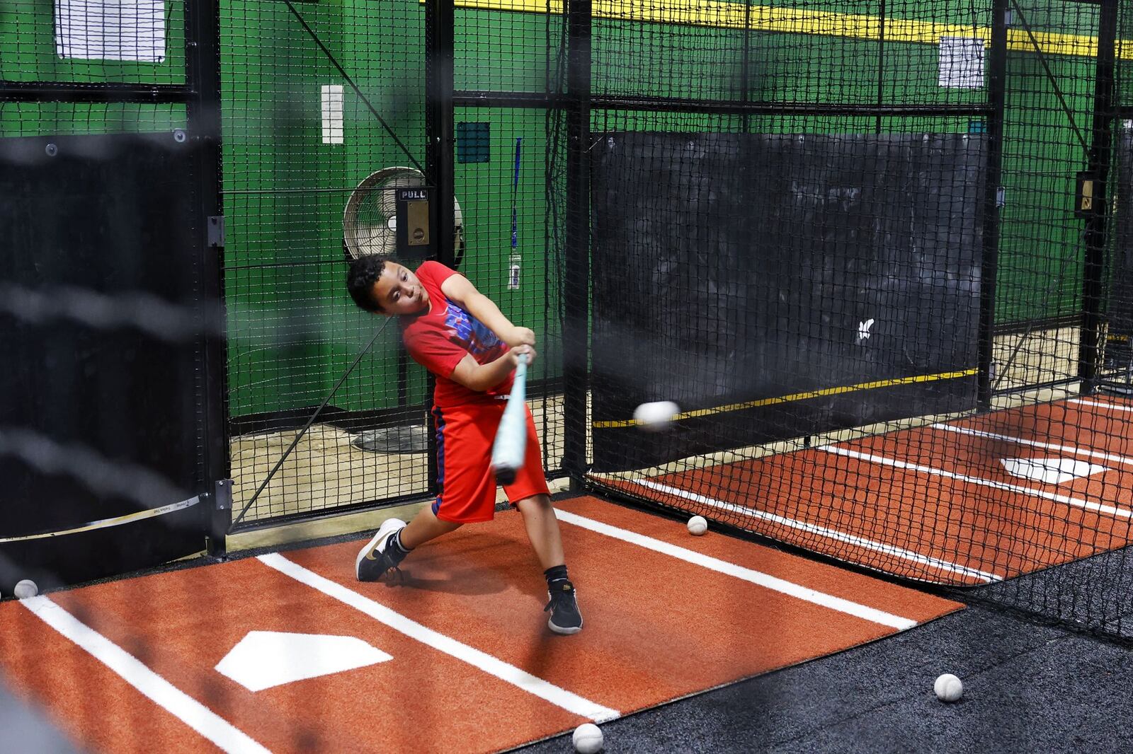 Jace Baker, 10, practices batting at The Yard sports development facility during their grand opening and ribbon cutting Wednesday, May 8, 2024 on Commerce Drive in Middletown. The new baseball and softball batting cage and training facility offers batting cages with HitTrax training system, pitching and batting training, pitching machines and more. NICK GRAHAM/STAFF