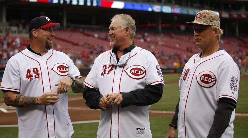 The former Reds relievers known as the Nasty Boys (from left, Rob Dibble, Norm Charlton and Randy Myers) will be a part of a sports memorabilia show taking place this weekend in Cincinnati. They're pictured here on July 7, 2014, at Great American Ball Park in Cincinnati. DAVID JABLONSKI/FILE