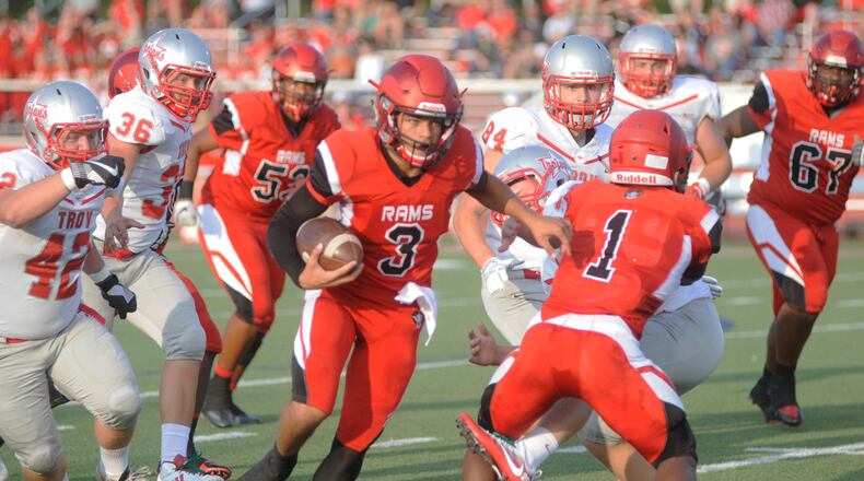 Trotwood’s Ra’veion Hargrove takes out a Troy defender for QB Markell Stephens-Peppers. Trotwood-Madison defeated Troy 48-0 in a Week 1 high school football game on Friday, Aug. 25, 2017. MARC PENDLETON / STAFF