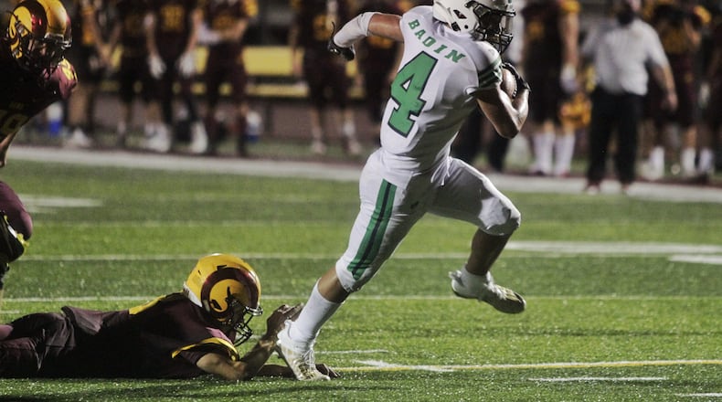 Badin running back Carter Russo slips past a Ross defender during their season opener at Ross on Friday, Aug. 28, 2020. Badin won 41-7. Nick Graham/STAFF