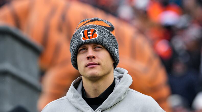 Cincinnati Bengals quarterback Joe Burrow (9) watches warmups before an NFL football game against the Cleveland Browns in Cincinnati, Sunday, Jan. 7, 2024. (AP Photo/Jeff Dean)
